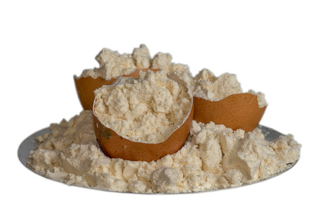 Egg protein powder on a plate and egg shells isolated on white background. sports nutrition.の写真素材