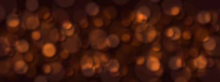 Abstract blurred orange confetti spots on a black background.の写真素材