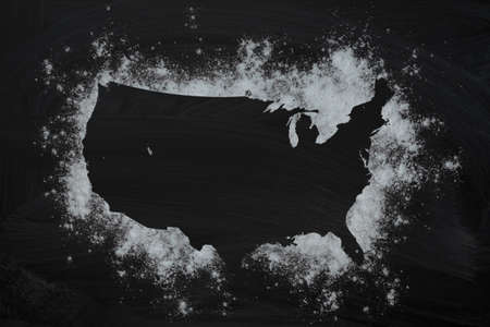 Frame with USA map from the flour on a dark background. Top view, copy space. food concept.の写真素材
