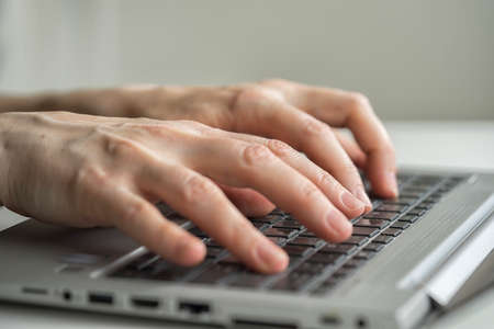 Hand typing on desktop keyboardの写真素材