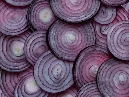 Red onion rings sliced and beautifully laid on the table in the backgroundの写真素材