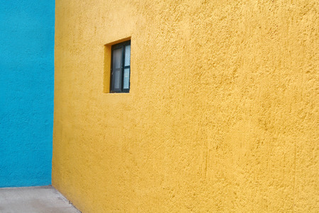 Yellow and blue wall with small window