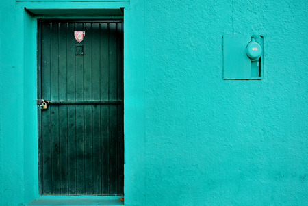 blue wall with door and electric meterの写真素材