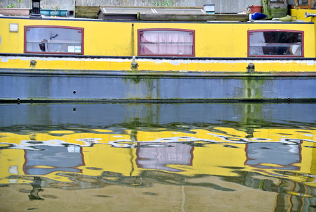 reflection of a yellow boat in the London canal,の写真素材