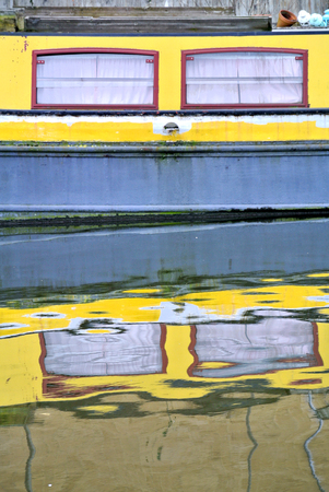 reflection of a yellow boat in the London canal,の写真素材