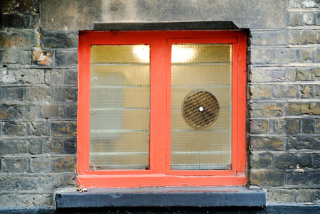 part of a building facade with small colored windows