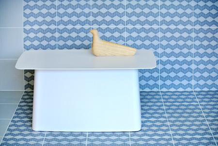 white metal table with decorative object and colorful tile backgroundの写真素材