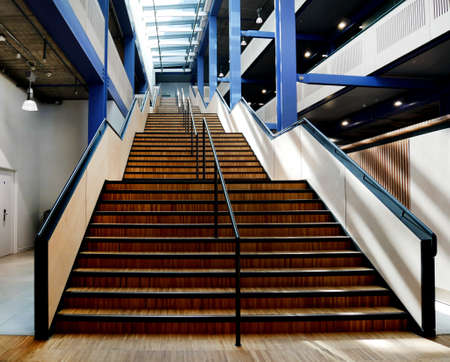 double internal wooden staircase with metal handrailの写真素材