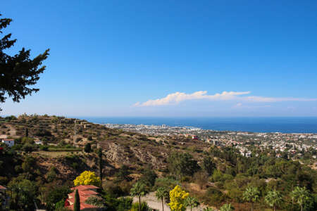 View from Bellapais Abbey of the restaurant's roofs, trees, Kyrenia, sea and blue sky. Cyprus.の写真素材