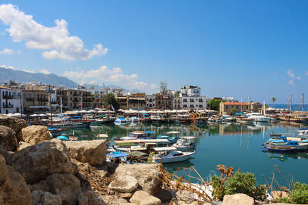 White pearl hotel in Kyrenia harbor on the background of the sky with clouds.のeditorial素材