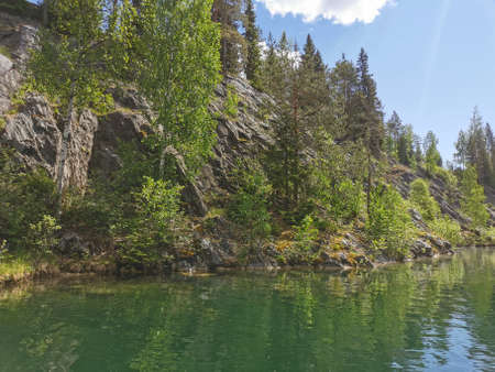 View of the rocky shores and the emerald water of the Marble Canyon in the Ruskeala Mountain Park on...
