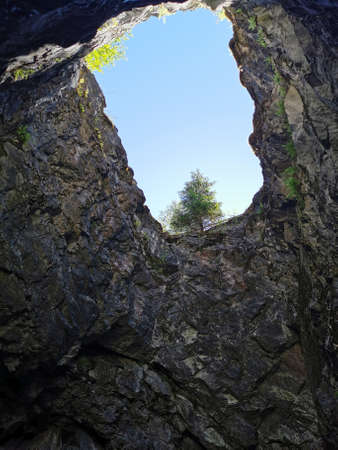 A view from below of the shaft of a vertical shaft, formerly used for marble mining, in the Ruskeala Mountain Park on a summer day.の写真素材