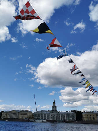 Flags decorating the Palace Bridge for the Navy Day on the background of the river and the blue sky...