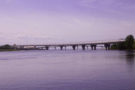 View of the water and two bridges: automobile and pedestrian on a lilac background.