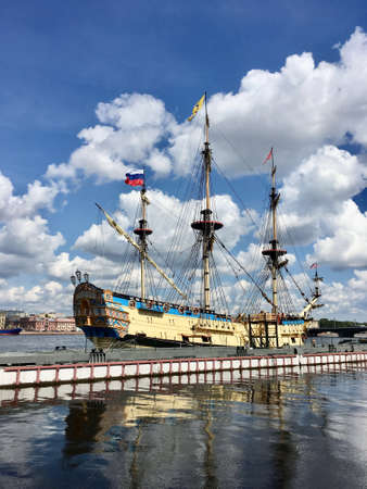 A beautiful sailing ship moored in the Neva river near the English embankment of St. Petersburg. Against the sky with beautiful clouds.の写真素材