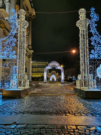 Festive illumination for Christmas and New Year in the form of fabulous gates and arches in the...