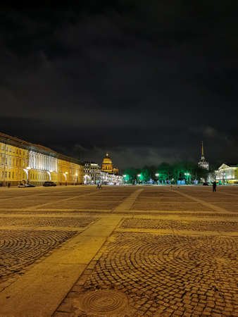 View from Palace Square to St. Isaac's Cathedral on a dark frosty winter morning against the background of a black sky with clouds.のeditorial素材