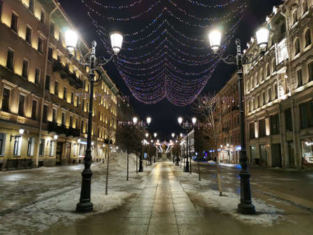 Festive illumination for Christmas and New Year on Malaya Konyushennaya Street in St. Petersburg on an early winter morning against the background of a black sky.のeditorial素材