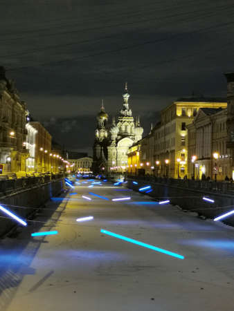 Griboyedov Canal in St. Petersburg, decorated with festive illumination for Christmas and New Year, in the distance the Savior on Spilled Blood on an early winter morning.のeditorial素材