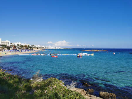 Protaras. Cyprus. The coast of the Mediterranean Sea with green plants and stones, a view of the...