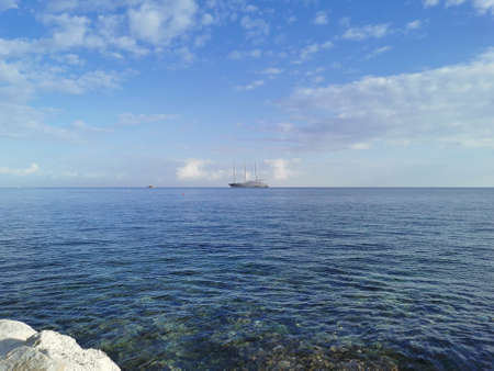 Protaras. Famagusta area. Cyprus. The largest sailing yacht in the world, an eight-deck motorsailer on the Mediterranean coast against a blue sky with beautiful clouds.の写真素材