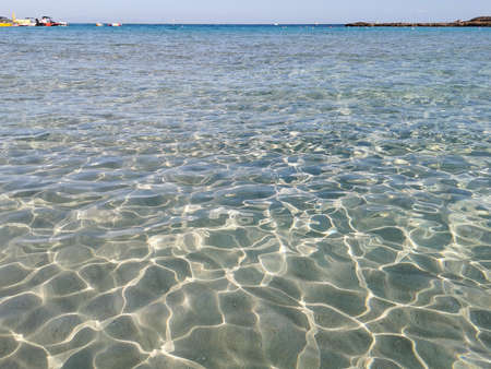 Protaras. Famagusta area. Cyprus. Fig Tree Bay beach, crystal clear water, white sand at the bottom, small island off the coast.の写真素材