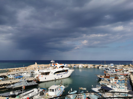 Protaras. Cyprus. Pier, port with small ships, yachts and boats in the bay of the Mediterranean Sea against the backdrop of a dramatic sky.のeditorial素材