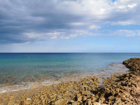 Protaras. Famagusta area. Cyprus. Stone coast of the Mediterranean Sea, turquoise water against a...