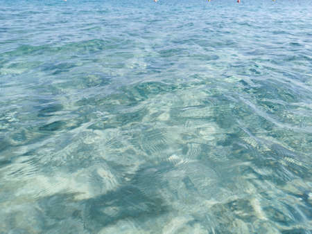 Protaras. Famagusta area. Cyprus. Crystal clear blue water of the Mediterranean Sea on the beach of Fig Tree Bay, white sand is visible at the bottom. water background.の写真素材