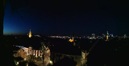 Panoramic view from the observation deck in the city center on the streets and buildings of Old and New Tallinn, on the tiled roofs, church spiers and new high-rise buildings. Evening in Estonia.の写真素材