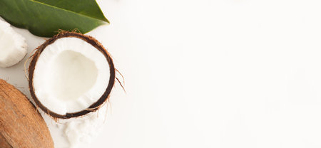 fresh coconut with scrub on white background. Home spa treatment concept, organic cosmetic....
