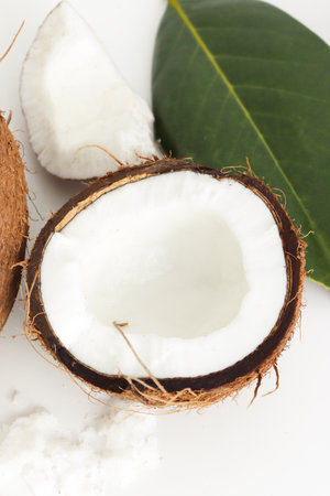 Fresh coconut on white background. Home spa treatment concept, organic cosmetic. Close up, vertical photoの写真素材