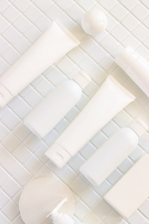 Skincare beauty cosmetic concept. White tube of cream lotion cleanser antioxidant facial oil on white background in a bathroom, verticalの写真素材