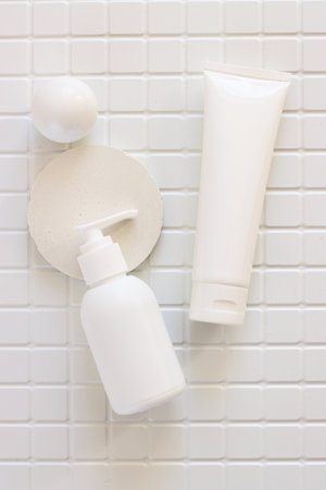 Skincare beauty cosmetic concept. White tube of cream lotion cleanser antioxidant facial oil on white background in a bathroom, verticalの写真素材