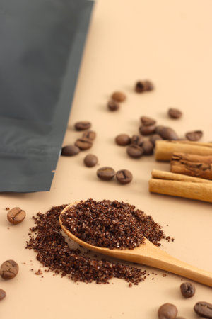 Home made texture scrub with cinnamon coffee on brown background. spa and home care concept, beauty procedures, vertical photo.の写真素材