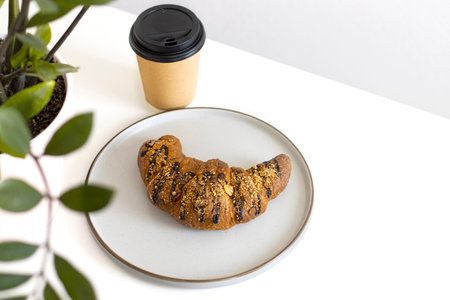 chocolate croissant on plate with and coffee. Concept Intuitive eating, breakfast, copyspaceの写真素材