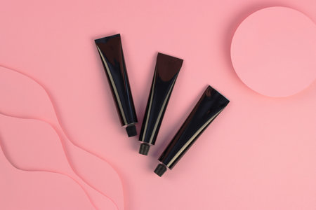Concept beauty, care, treatment. Set with cream tube and paper sun waves on pink background. High quality photo.の写真素材