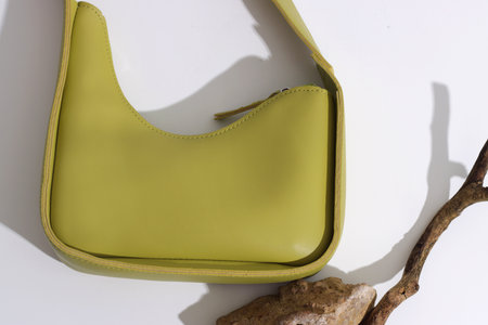 Green eco bag on white background. Concept of vegan leather, sustainable alternative, nature protection, zero waste lifestyle, no waste production. High quality photoの写真素材
