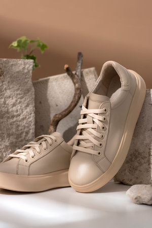Comfortable sneakers on stone. Concept active eco lifestyle, cusual, shoes for moms, business woman, handmade. verticalの写真素材