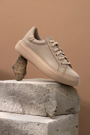 Comfortable sneakers on stone. Concept active eco lifestyle, casual, shoes for moms, business woman, handmade. verticalの写真素材