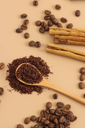 Home made texture scrub with cinnamon coffee on brown background. spa and home care concept, beauty procedures, vertical photoの写真素材
