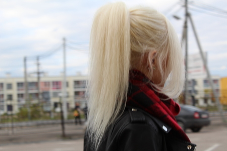 The blonde girl looks into the distance.の写真素材