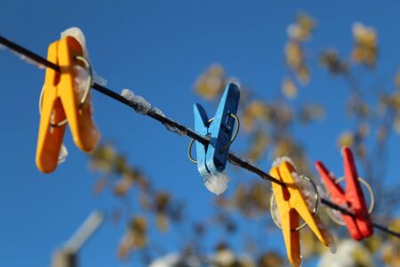 clothespins for drying clothes on a ropeの写真素材