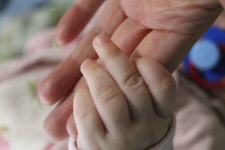 hands of a mother and a small child is loveの写真素材