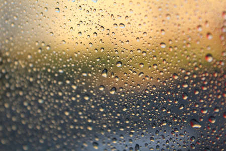 beautiful background of water drops on the glass from the rainの写真素材