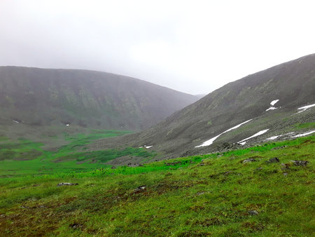 beautiful mountains of the Northern Urals with snow in summerの写真素材
