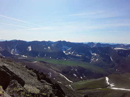 beautiful mountains of the Northern Urals with snow in summerの写真素材