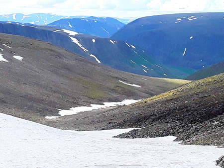 beautiful mountains of the Northern Urals with snow in summerの写真素材