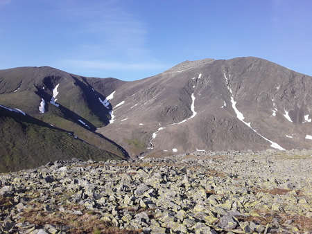 beautiful mountains of the Northern Urals with snow in summerの写真素材