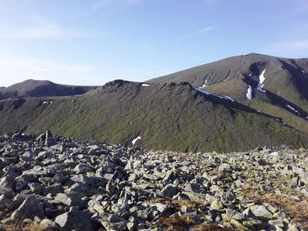beautiful mountains of the Northern Urals with snow in summerの写真素材